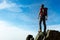 Climber arrive on the summit of a mountain peak. Concepts: victo