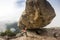 Climber is bouldering in nature. Girl climbs on a big stone. Woman doing sports outdoors. Athlete is engaged in activity