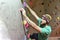 Climber bouldering in a sports hall - holding on to the handle o