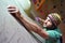 Climber bouldering in a sports hall - holding on to the handle o