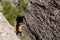 climber boy. a child in a helmet climbs a rock. sports on the street