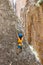 climber boy. a child in a helmet climbs a rock. sports on the street