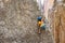 climber boy. a child in a helmet climbs a rock. sports on the street