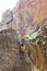 climber boy. a child in a helmet climbs a rock. sports on the street