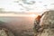 Climber climbing a rock in the mountain at sunset. Hiker climbing a rock