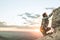 Climber climbing a rock in the mountain at sunset. Hiker climbing a rock