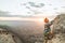 Climber climbing a rock in the mountain at sunset. Hiker climbing a rock