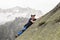 Climber climbs on a sloping rock wall in the Swiss mountains