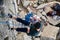 A Climber descending with the rope after climbing a rock wall.