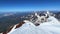 A climber descends from the top of Mount Kazbek. A majestic panorama of mountains, rocks and hills