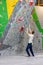 Climber explores and develops a route on a climbing wall in the boulder hall