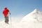 Climber facing wind and snow on mountain summit