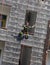 climber of firefighters rappelling the wall during the fire drill