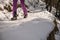 Climber on a frozen waterfall. Crampons close-up on his feet ice climber