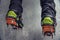 Climber on a frozen waterfall. Crampons close-up on his feet ice climber