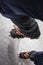 Climber on a frozen waterfall. Crampons close-up on his feet ice climber