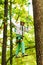 Climber girl engaged in training between trees