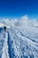 Climber on a knife edge snow mountain ridge