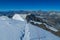 Climber on a knife edge snow mountain ridge