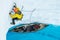 Climber leading ice out of an inflatable canoe on steep ice on the Matanuska Glacier in Alaska