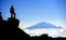 Climber on Mt Kilimanjaro with view of Mt Meru