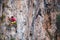 Climber overcomes a difficult climbing route on a natural terrain