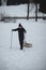 Climber pulls to the top of a wooden sled to ride on the piste. Pause for rest. Candid portrait of a man pulling a sledge, which