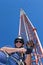 Climber puts safety equipment of before climbing tower