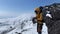 The climber puts on warm mittens during strong winds and snowfalls.