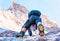 Climber reaches the summit of mountain peak. Climbing and mountaineering sport concept