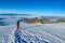 Climber on snow mountain ridge above the clouds