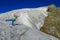 Climber on snow mountain ridge above the clouds