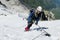 Climber on snow summit, rocky mountain peaks and glacier