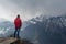 Climber standing at the edge at the mountains