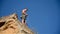 Climber Standing On Top Of Cliff