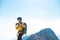 climber on top of the mountain takes a photo. Woman traveler takes a photo on a modern smartphone, makes beautiful pictures of