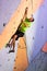 Climber trying to reach a hold on Climbing Wall