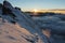 Climber walking steep ridge in beautiful sunset