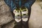 Climber woman with her climbing shoes placed on her hands.