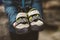 Climber woman with her climbing shoes placed on her hands.