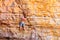 Climbers boulder on sandstone rocks on the beach