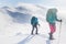 climbers climb the mountain in the snow. Winter mountaineering. two girls in snowshoes walk through the snow. mountaineering