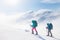 climbers climb the mountain in the snow. Winter mountaineering. two girls in snowshoes walk through the snow. mountaineering