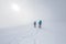 climbers climb the mountain. Winter mountaineering. two girls in snowshoes walk through the snow