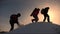 Climbers climb one after another on a snow-covered hill. team of business people go to victory and success. teamwork of