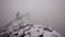 Climbers Climbing a Mountain in the Fog