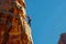 Climbers conquering challenging rock formations in mountain.