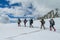 Climbers on glacier traver mountain route attached to the alpinist rope