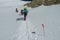 Climbers on glacier traver mountain route attached to the alpinist rope