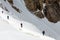 Climbers Linked with Protection Rope Ascending Glacier